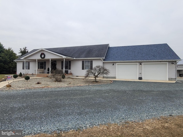 ranch-style house with a porch and a garage