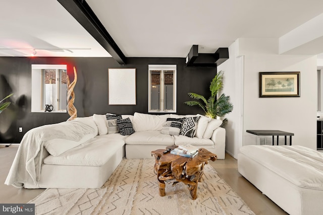 living room with light wood-type flooring and beamed ceiling