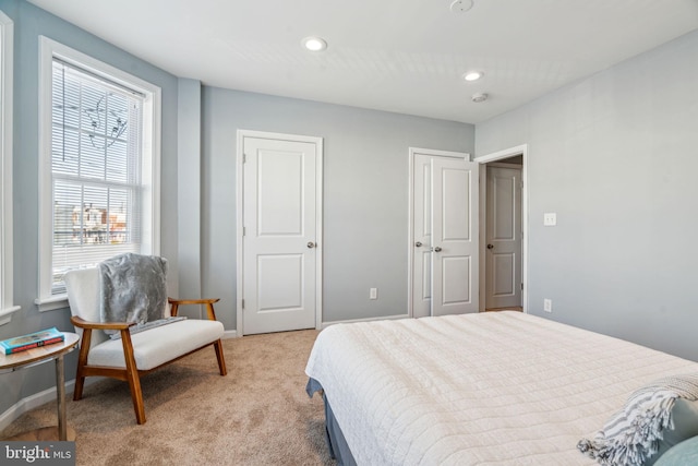 bedroom featuring light carpet