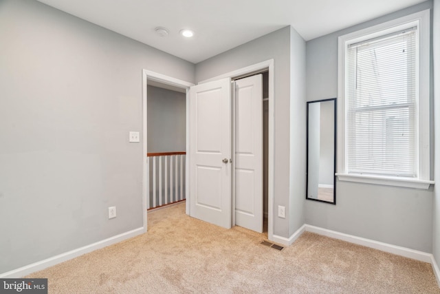 unfurnished bedroom with light carpet