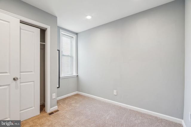 unfurnished bedroom with light colored carpet