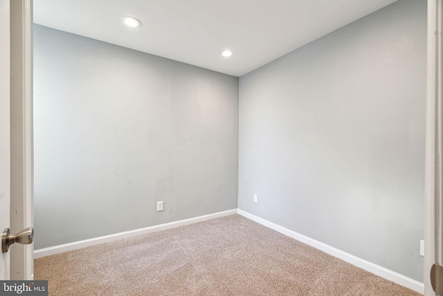 spare room featuring light colored carpet