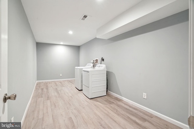 laundry area featuring independent washer and dryer and light wood-type flooring