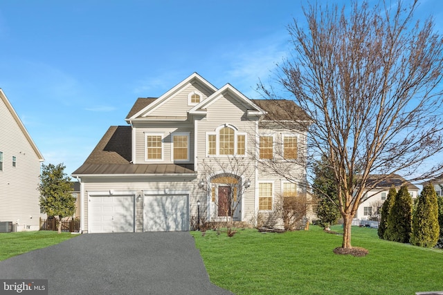 view of front of house with a garage and a front yard