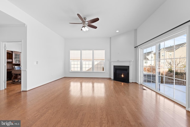 unfurnished living room with hardwood / wood-style flooring and ceiling fan