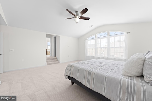 carpeted bedroom with ceiling fan and lofted ceiling