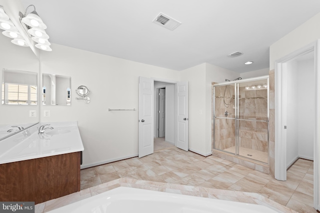 bathroom featuring vanity and separate shower and tub