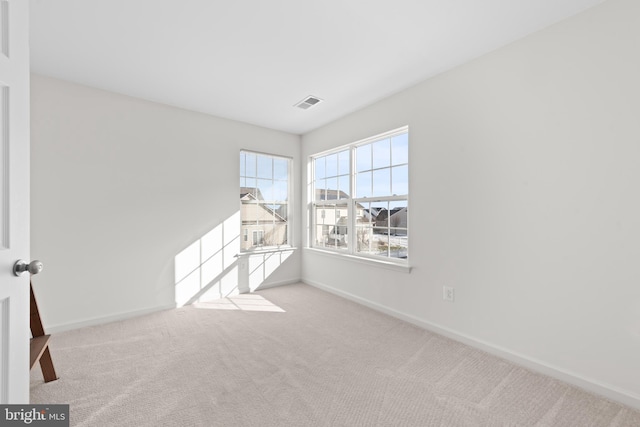 unfurnished room featuring light colored carpet