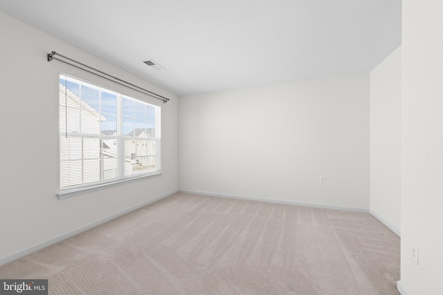 empty room with light colored carpet