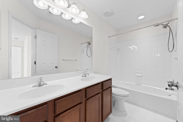 full bathroom with tiled shower / bath, vanity, toilet, and tile patterned flooring