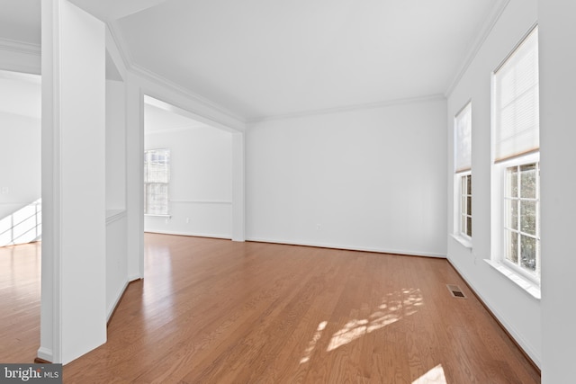 empty room featuring crown molding and hardwood / wood-style floors