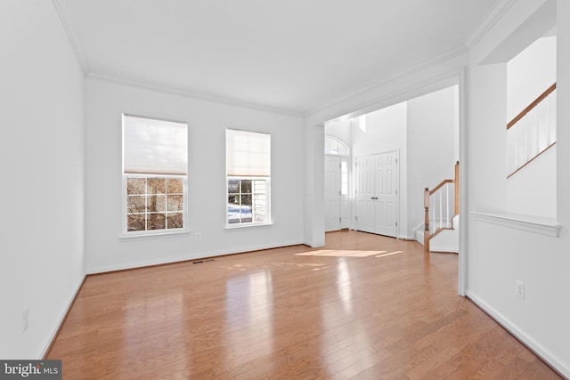 unfurnished living room featuring crown molding and light hardwood / wood-style flooring