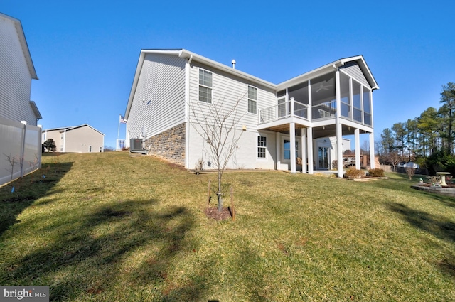 rear view of property featuring central AC, a yard, a patio area, and a sunroom