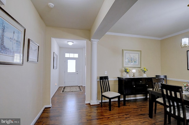 entryway with dark hardwood / wood-style flooring, crown molding, and ornate columns