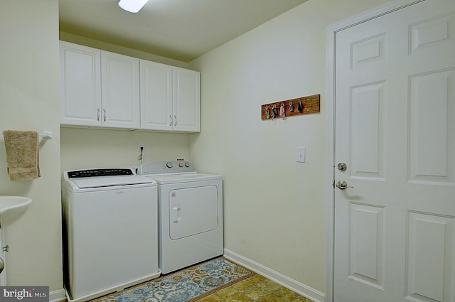 laundry room with washer and clothes dryer and cabinets