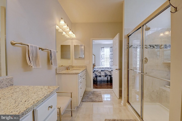 bathroom with vanity, tile patterned flooring, and a shower with door