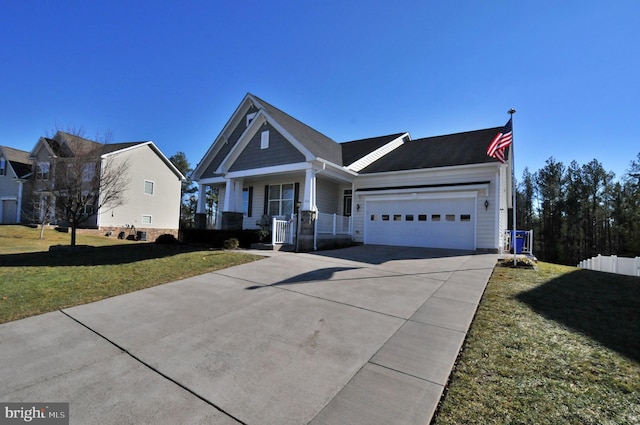 view of front of house featuring a garage, a porch, and a front yard