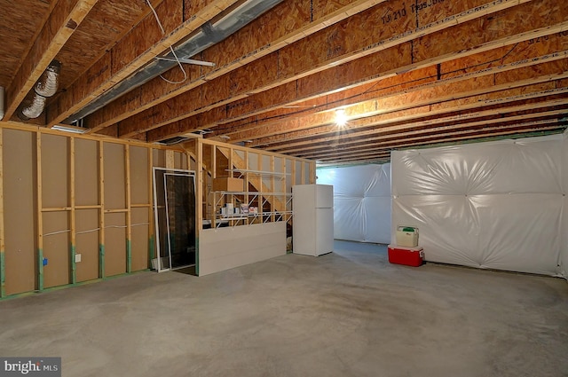 basement featuring white refrigerator