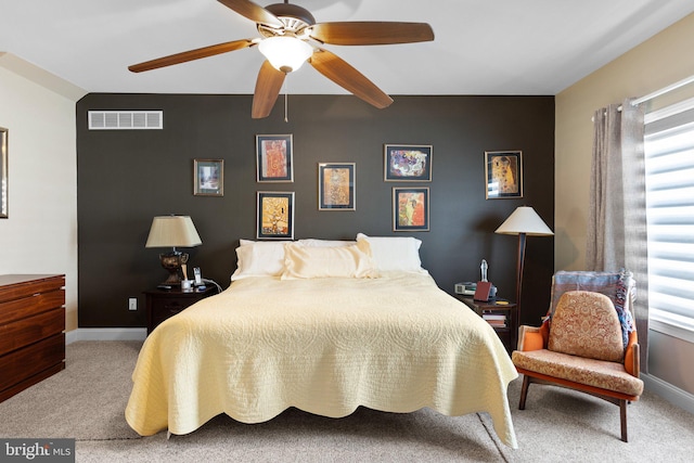 bedroom featuring multiple windows, carpet floors, and ceiling fan