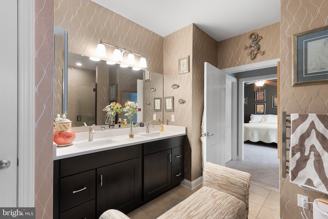 bathroom featuring tile patterned flooring, walk in shower, and vanity