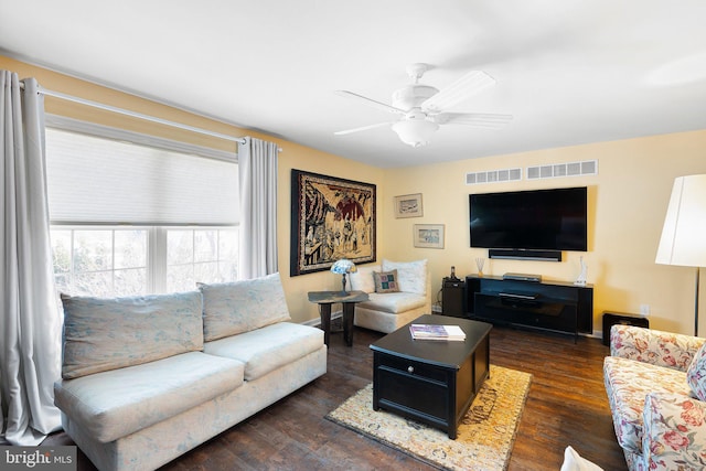 living room with ceiling fan and dark hardwood / wood-style flooring