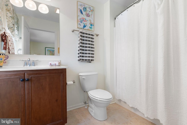 bathroom featuring toilet, vanity, and tile patterned flooring