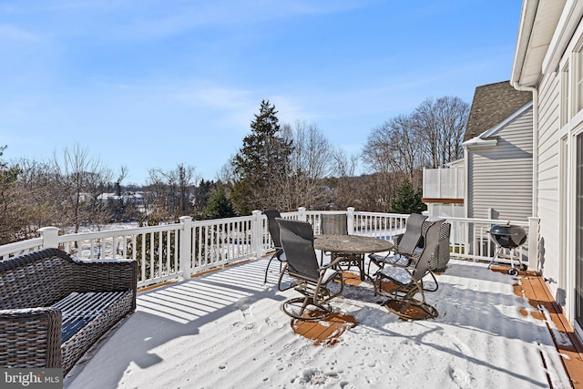 snow covered deck with a grill