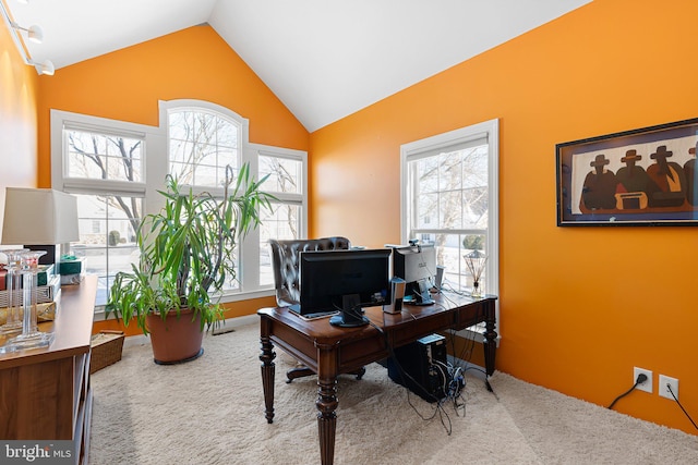 home office with carpet floors and vaulted ceiling