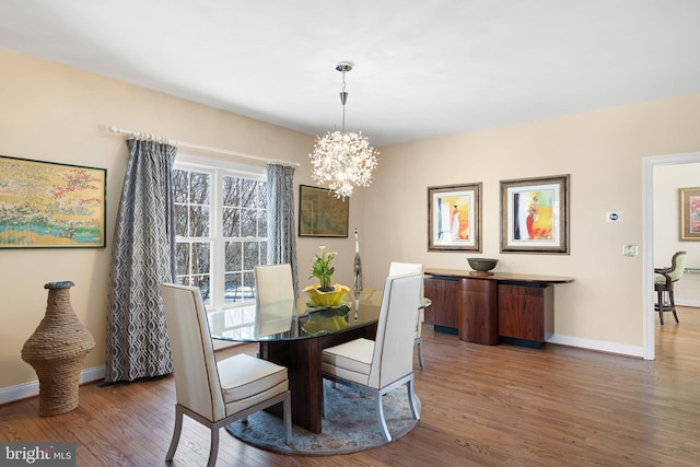 dining area with an inviting chandelier and wood-type flooring