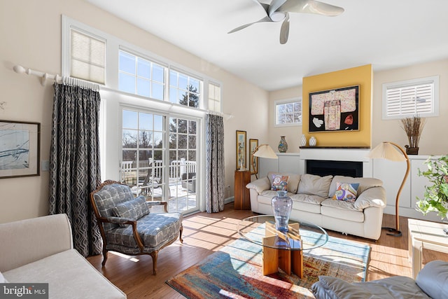 living room with light wood-type flooring and ceiling fan