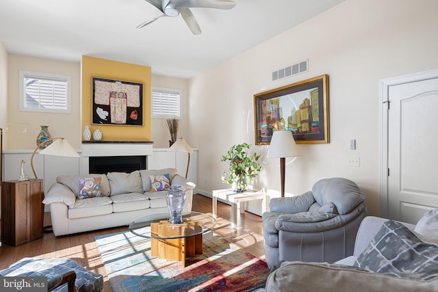 living room featuring hardwood / wood-style flooring, ceiling fan, and plenty of natural light