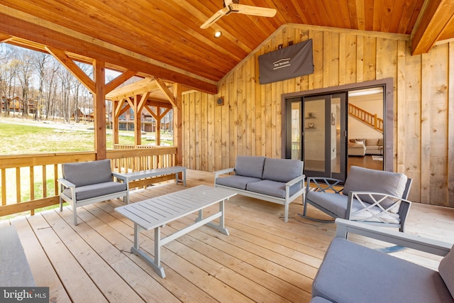 deck with an outdoor living space and ceiling fan