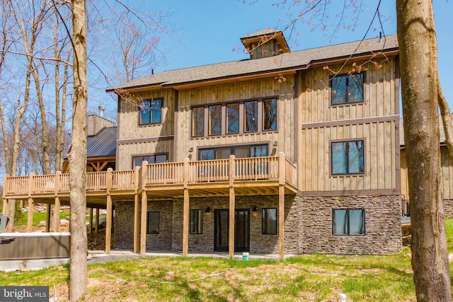 rear view of property featuring a yard and a deck