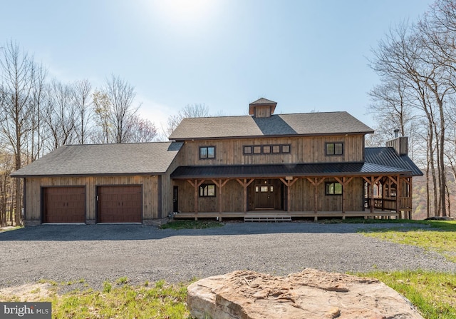 view of front of home with a garage and a porch