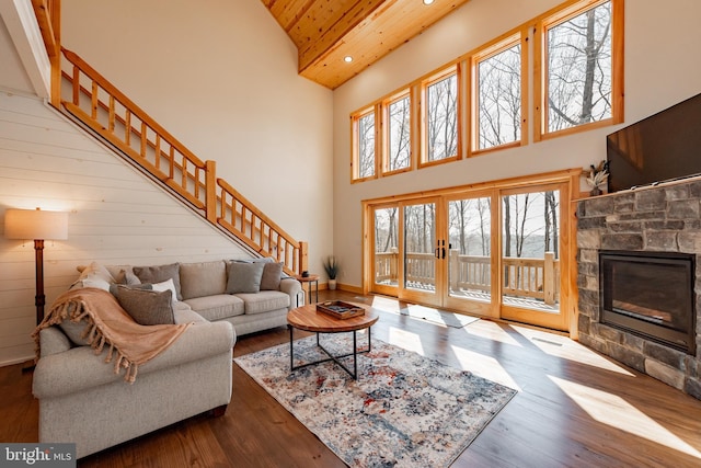 living room with hardwood / wood-style flooring, wood ceiling, high vaulted ceiling, and a fireplace