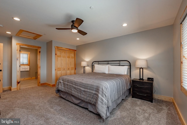 bedroom with light carpet, a closet, ceiling fan, and ensuite bathroom