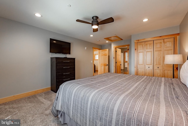 bedroom with a closet, ceiling fan, and carpet flooring