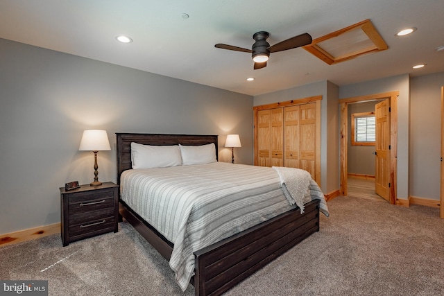 carpeted bedroom with ceiling fan and a closet