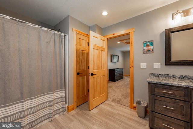 bathroom featuring vanity and wood-type flooring