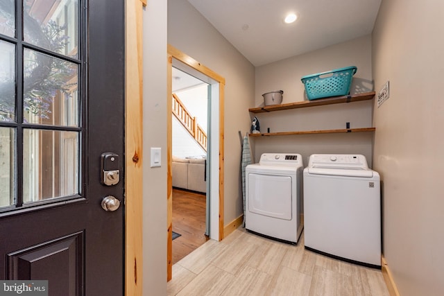 laundry room with independent washer and dryer and light wood-type flooring