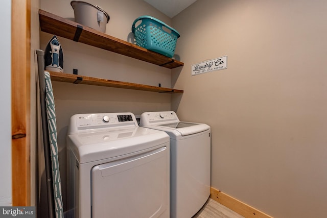 clothes washing area with separate washer and dryer