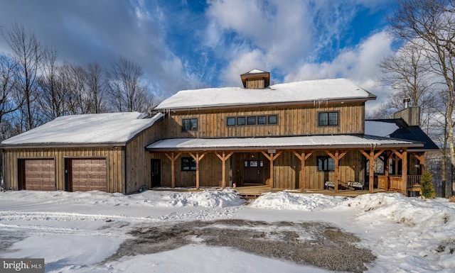 view of front of property featuring a garage and covered porch