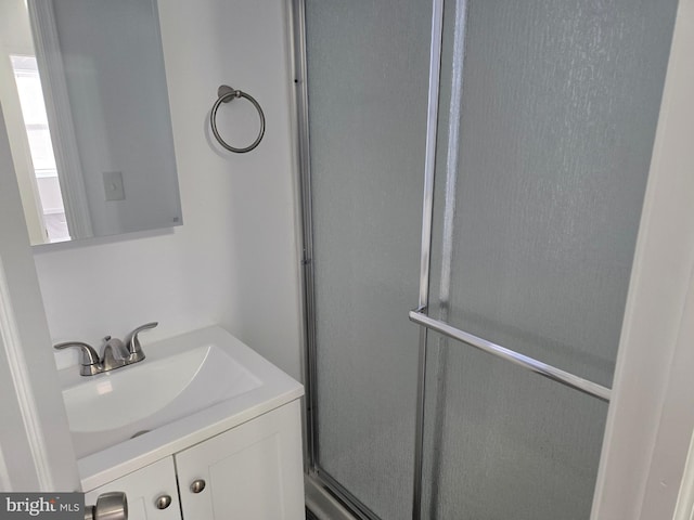 bathroom featuring vanity and an enclosed shower