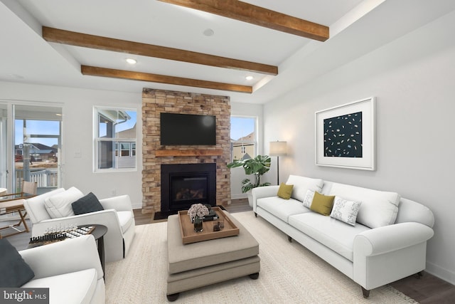 living room featuring light wood-type flooring, plenty of natural light, and a fireplace