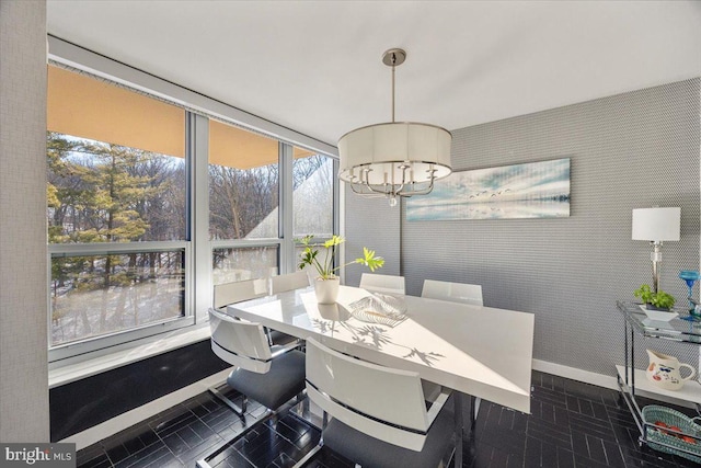 tiled dining space featuring a notable chandelier