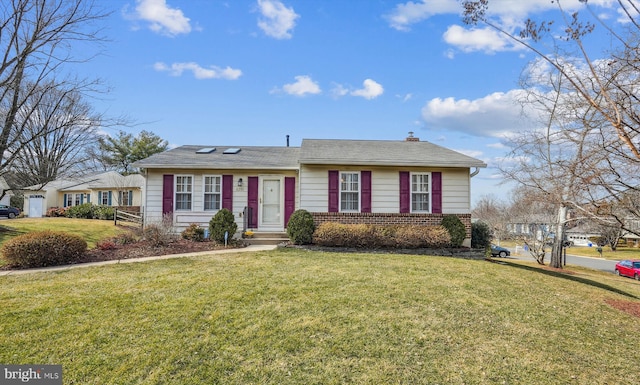 single story home featuring brick siding, a chimney, and a front lawn