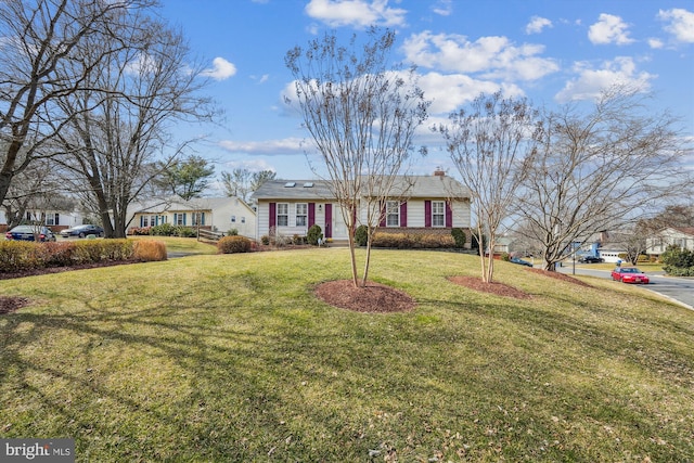 view of front of property featuring a chimney and a front lawn