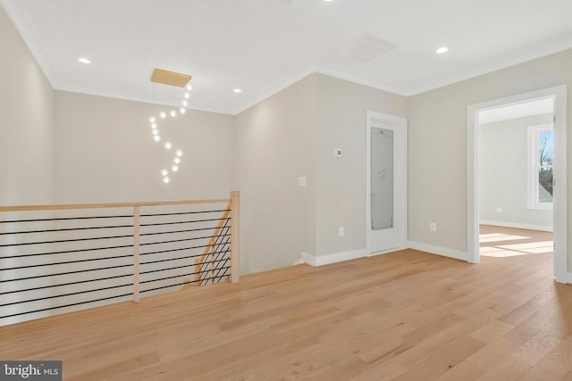 unfurnished room with crown molding and light hardwood / wood-style floors