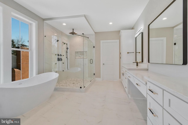 bathroom featuring vanity and independent shower and bath