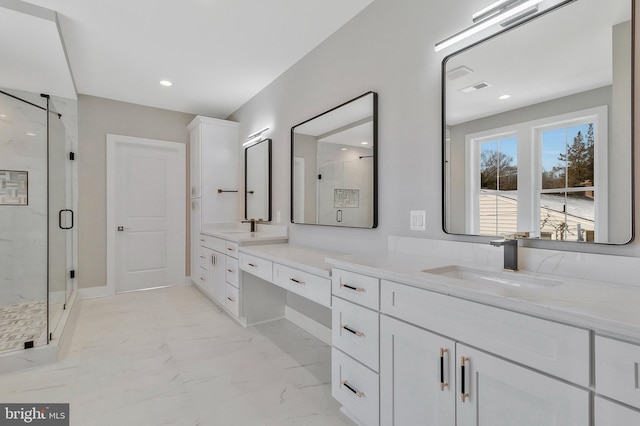 bathroom with vanity and a shower with door